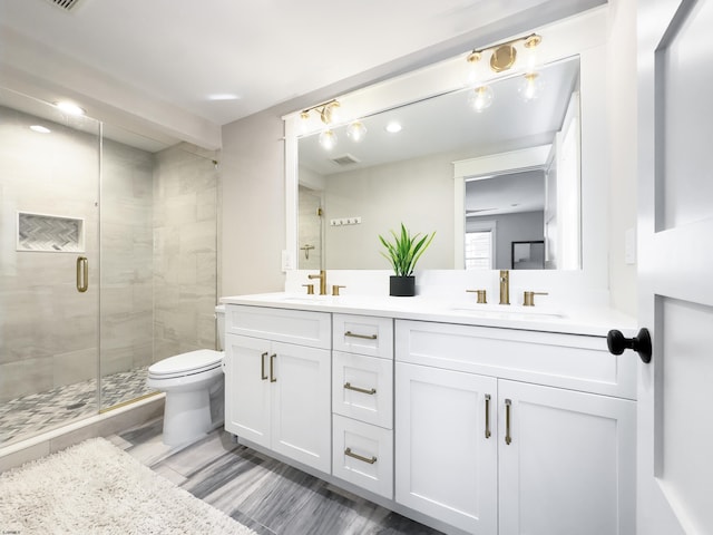 full bathroom with visible vents, double vanity, toilet, a sink, and a stall shower