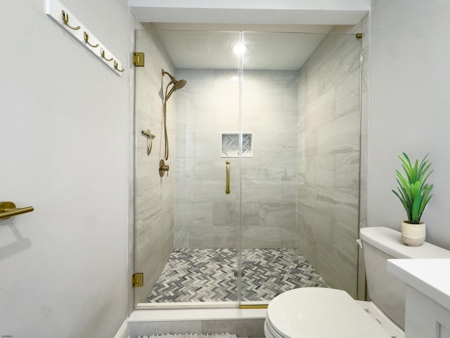 full bathroom featuring toilet and a shower stall