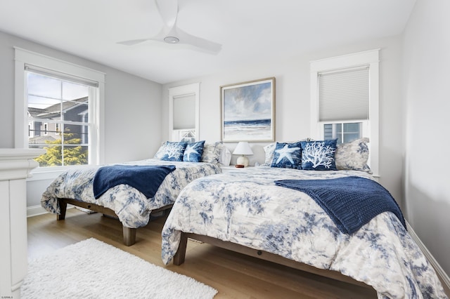 bedroom with ceiling fan and wood finished floors