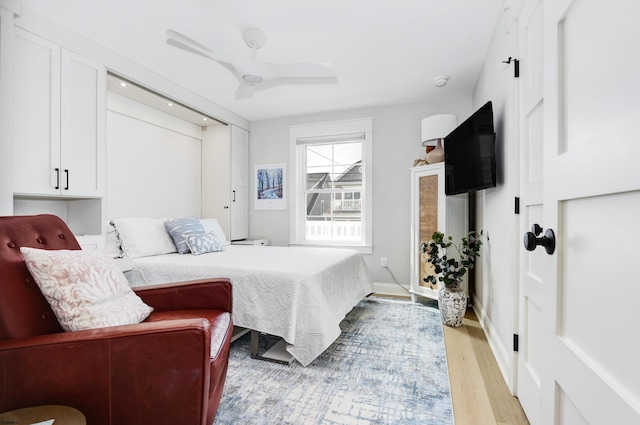 bedroom with ceiling fan and light wood-type flooring