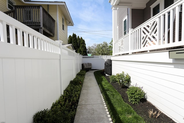 view of property exterior with a fenced backyard and a balcony