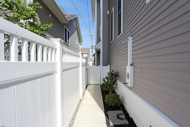 view of home's exterior featuring fence and a gate