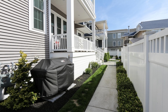 view of home's exterior with fence and a residential view