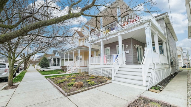 view of front of home featuring a porch and a balcony