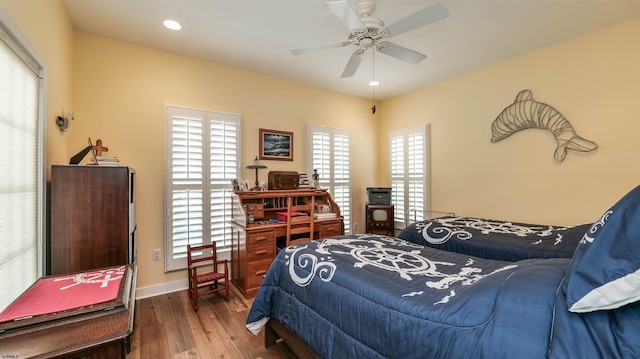 bedroom featuring wood-type flooring, recessed lighting, baseboards, and a ceiling fan