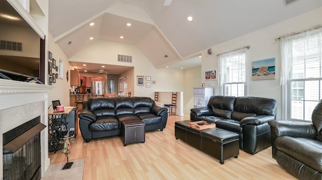 living room with visible vents, high vaulted ceiling, recessed lighting, a ceiling fan, and light wood finished floors