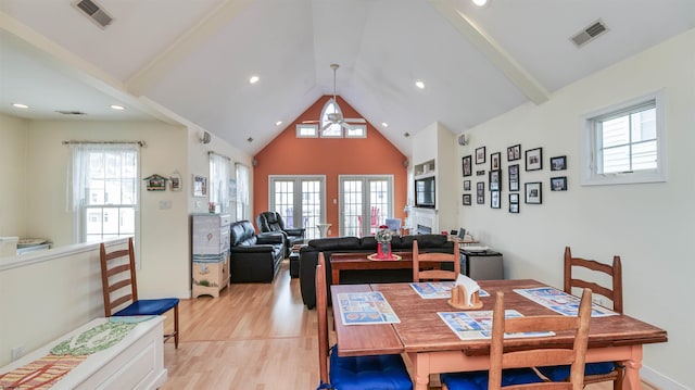 dining area featuring a healthy amount of sunlight, a ceiling fan, light wood finished floors, and visible vents