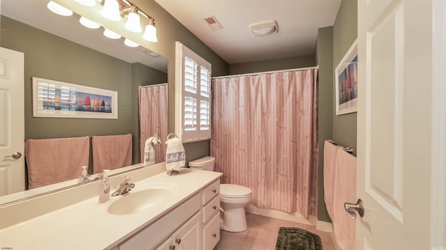 bathroom with visible vents, vanity, toilet, a shower with shower curtain, and tile patterned floors