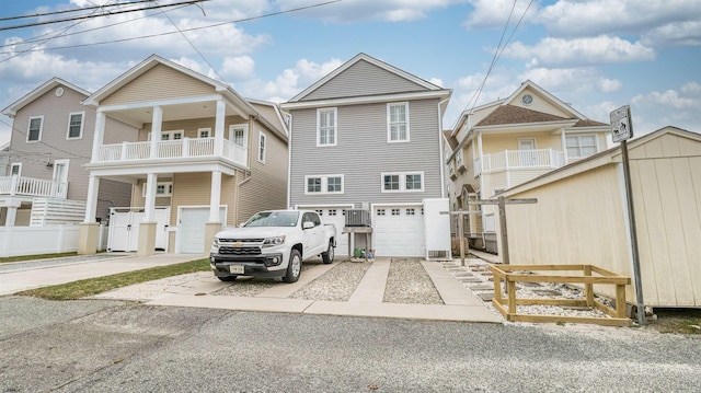 view of front of house with a garage, a balcony, and driveway