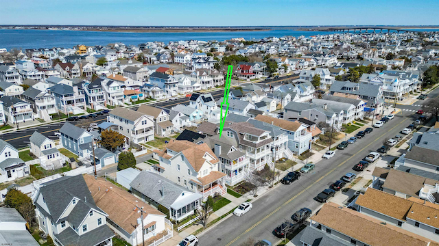 drone / aerial view featuring a water view and a residential view