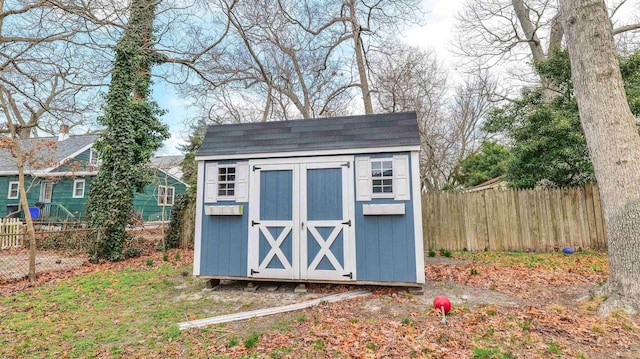 view of shed featuring fence