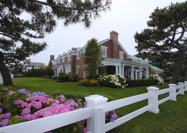 view of property exterior with a lawn and a fenced front yard