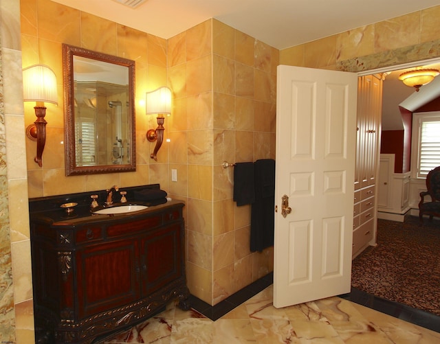 full bathroom with vanity, visible vents, and tile walls