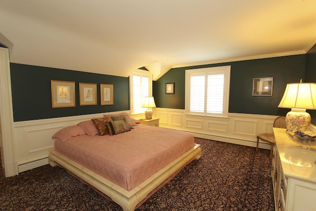carpeted bedroom featuring wainscoting, lofted ceiling, and a decorative wall