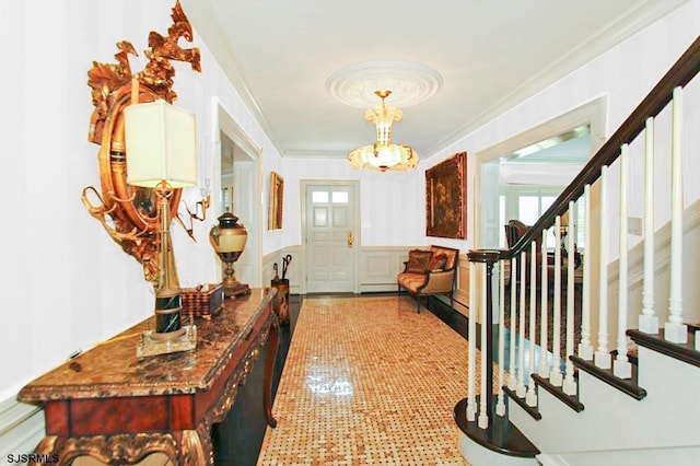 foyer with ornamental molding, stairs, and a wealth of natural light