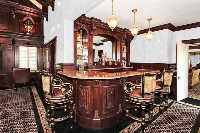 bar with crown molding, carpet, wet bar, and a wainscoted wall