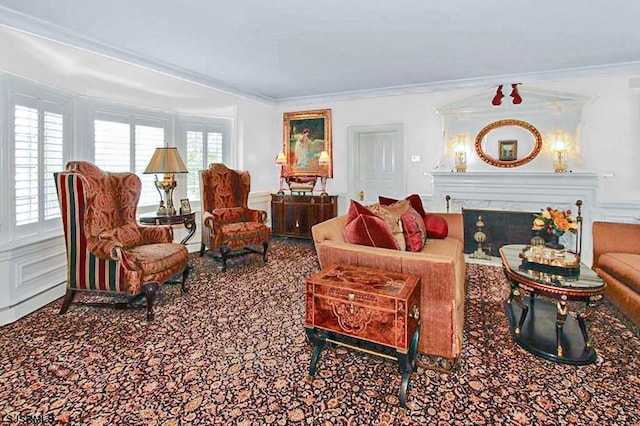 living area featuring crown molding and a fireplace