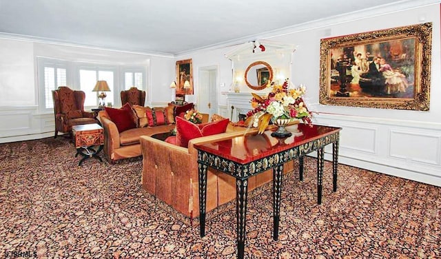 living area featuring crown molding, carpet floors, a wainscoted wall, and a decorative wall