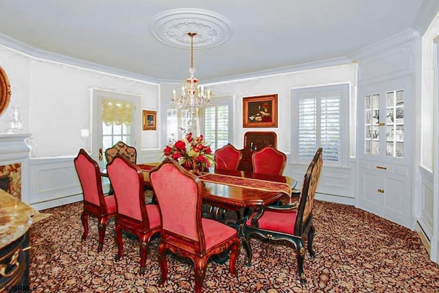 carpeted dining space featuring crown molding, a wealth of natural light, a decorative wall, and a notable chandelier