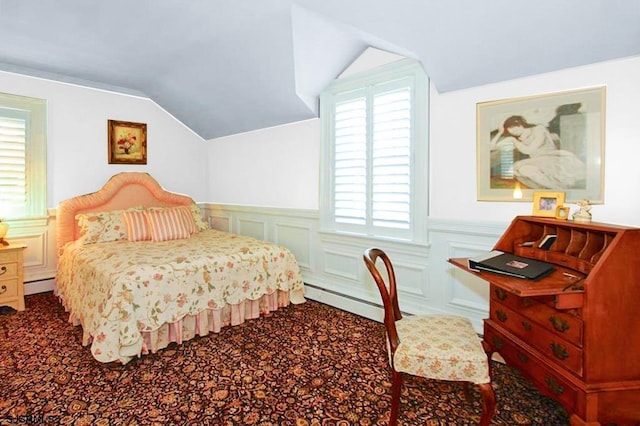 bedroom with multiple windows, baseboard heating, and lofted ceiling