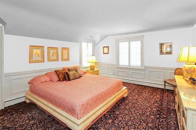 bedroom with a decorative wall, carpet flooring, lofted ceiling, and a wainscoted wall