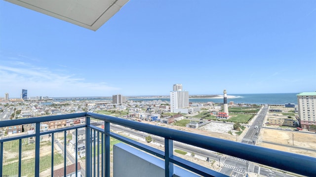 balcony featuring a water view and a city view