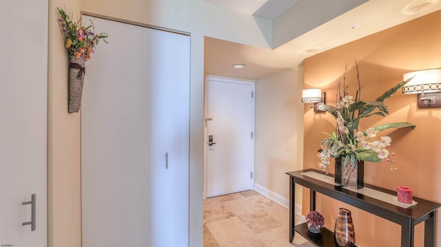 hallway featuring recessed lighting and baseboards
