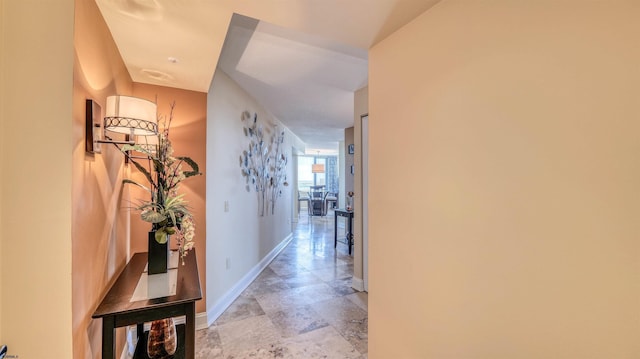 hall featuring baseboards