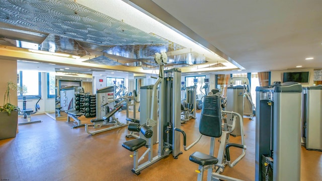 exercise room featuring recessed lighting and a healthy amount of sunlight