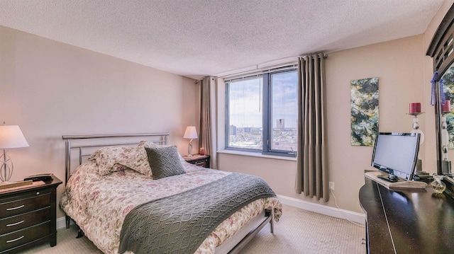 carpeted bedroom featuring baseboards and a textured ceiling