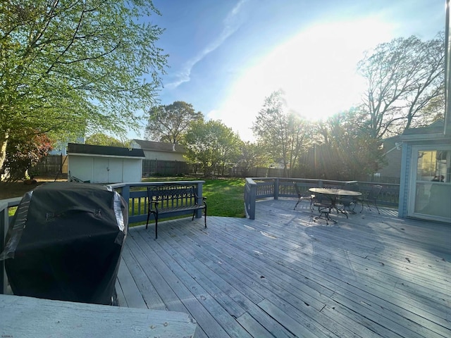 306 W Revere Ave, Northfield, NJ 08225 - wooden terrace with outdoor dining area, a storage shed, a fenced backyard, an outdoor structure, and grilling area