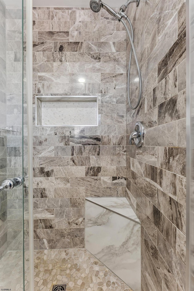 bathroom with a tile shower