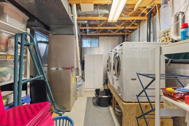 below grade area featuring washing machine and clothes dryer
