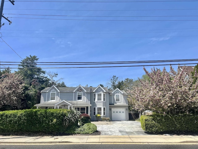 view of front of home with driveway and a garage