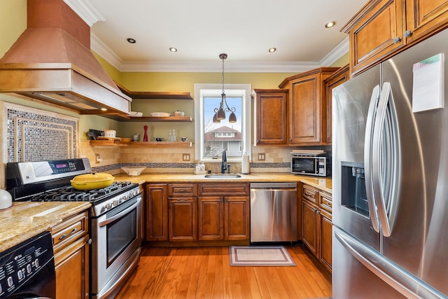 kitchen with a sink, brown cabinetry, light wood-style flooring, stainless steel appliances, and backsplash