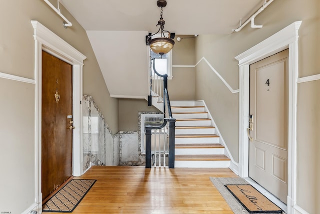 entrance foyer with wood-type flooring and stairs