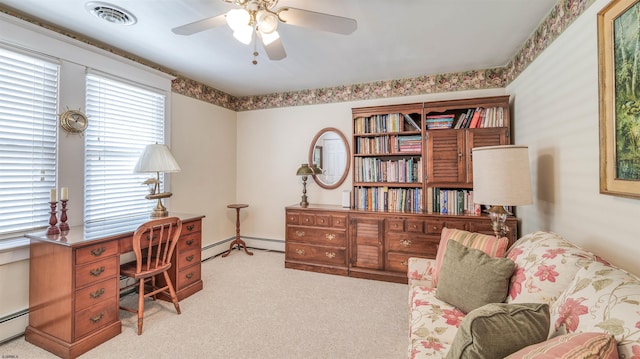 office space with a baseboard radiator, a ceiling fan, carpet flooring, and visible vents
