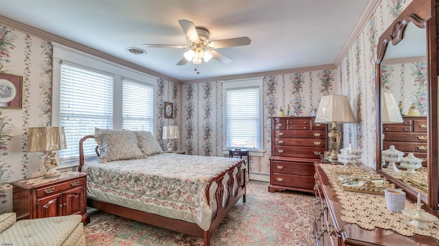 bedroom with ceiling fan, visible vents, a baseboard heating unit, ornamental molding, and wallpapered walls