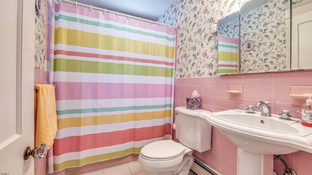bathroom with tile patterned flooring, toilet, tile walls, a wainscoted wall, and a shower with curtain