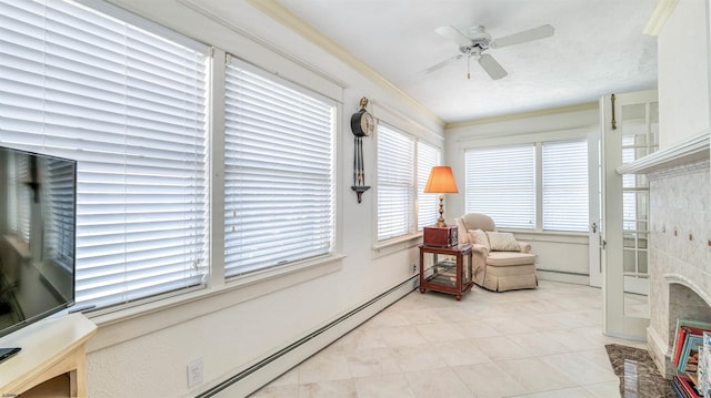 sitting room featuring ceiling fan, a fireplace, light tile patterned floors, a baseboard radiator, and ornamental molding