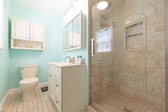 full bath featuring vanity, baseboards, a stall shower, and toilet