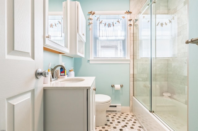 bathroom with vanity, tile patterned flooring, toilet, baseboards, and a baseboard radiator