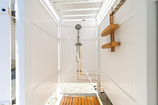 mudroom with a decorative wall and wood finished floors
