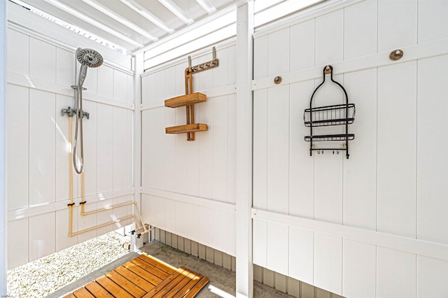 mudroom with concrete floors and a decorative wall