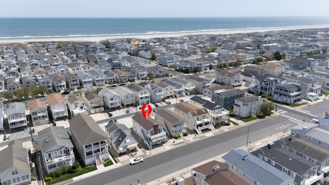 drone / aerial view featuring a residential view and a water view
