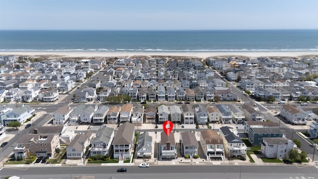 bird's eye view with a water view, a beach view, and a residential view