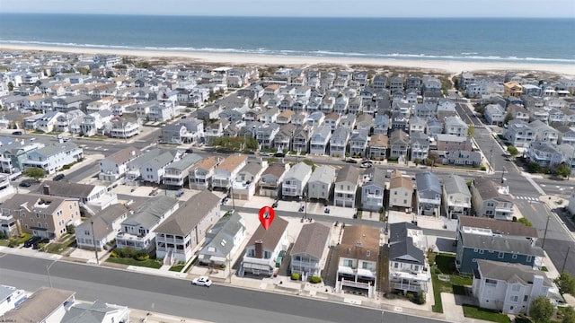 bird's eye view with a residential view, a view of the beach, and a water view