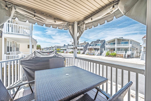balcony featuring a residential view and outdoor dining space