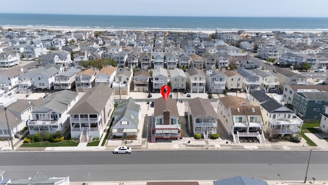 drone / aerial view with a water view and a residential view
