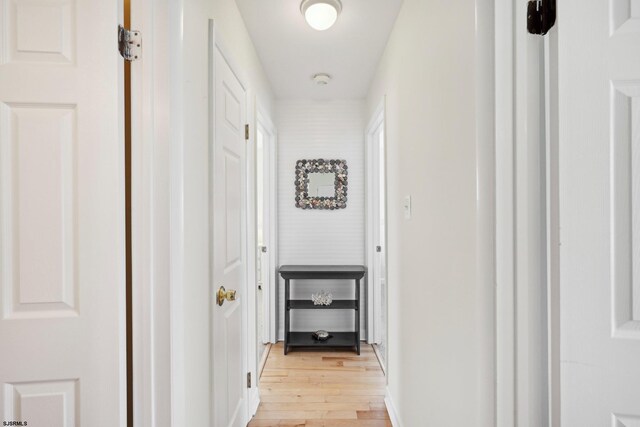 corridor featuring light wood finished floors